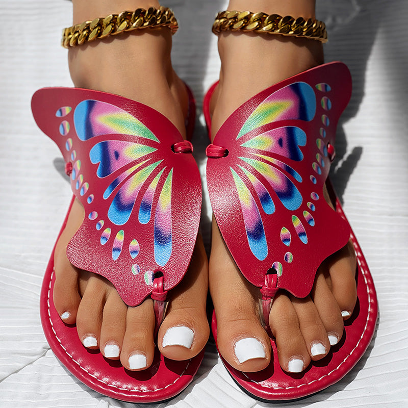 Red butterfly sandals with rainbow wings, gold chain anklets, white nail polish